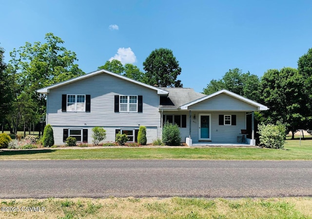 split level home with a front lawn and a porch