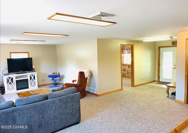 carpeted living room with visible vents and baseboards