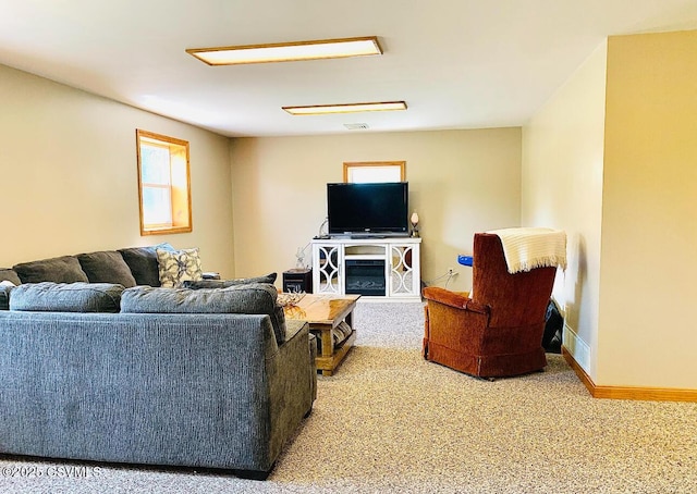 living area featuring carpet floors and baseboards