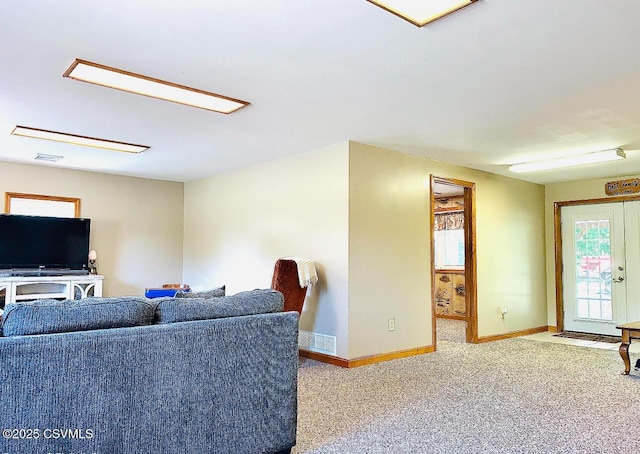 carpeted living room with visible vents and baseboards