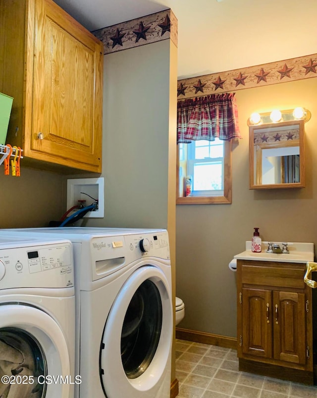 washroom featuring light tile patterned flooring, a sink, washer and dryer, laundry area, and baseboards