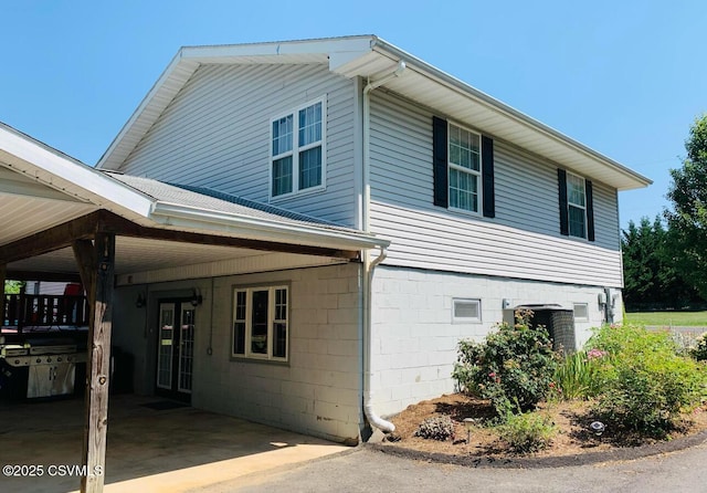 view of property exterior with a carport