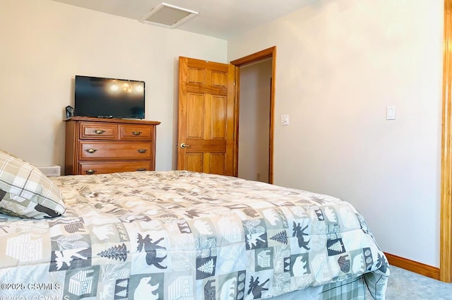 bedroom with carpet, attic access, and baseboards