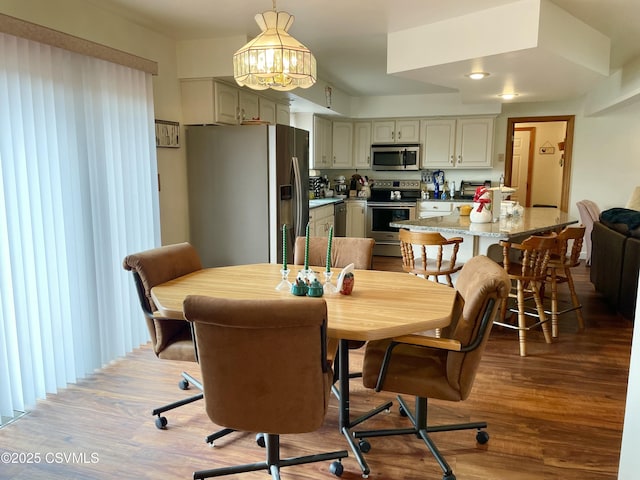 dining room featuring a notable chandelier and wood finished floors