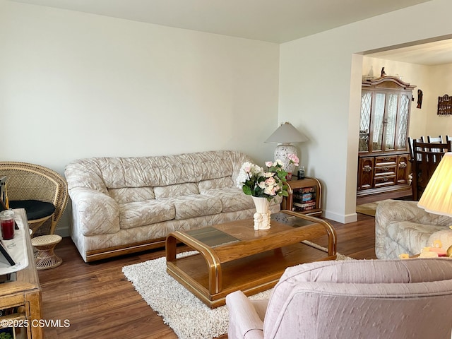 living area featuring dark wood finished floors and baseboards