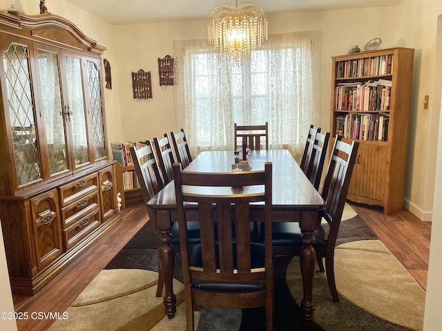 dining space with an inviting chandelier and wood finished floors