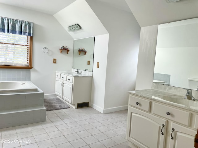 bathroom featuring two vanities, a sink, vaulted ceiling, a bath, and tile patterned floors