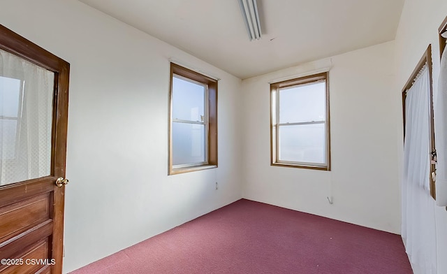 unfurnished room featuring dark carpet