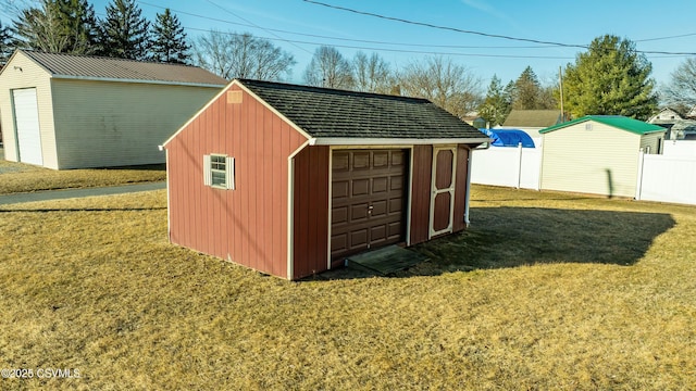 view of shed featuring fence