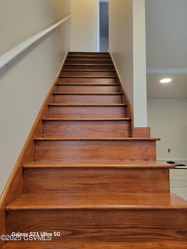 staircase featuring recessed lighting