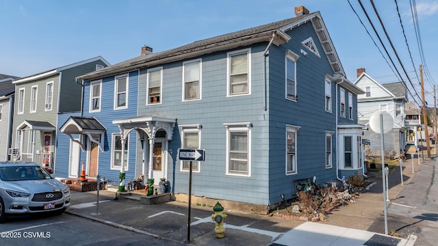 multi unit property featuring a residential view and a chimney