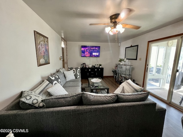 living room with wood finished floors and a ceiling fan