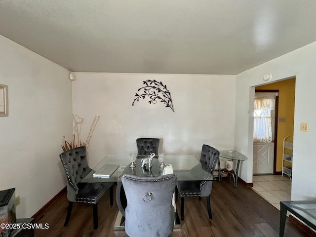 interior space with baseboards and wood finished floors