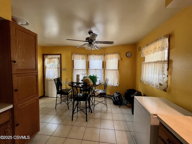 dining room featuring ceiling fan and light tile patterned flooring