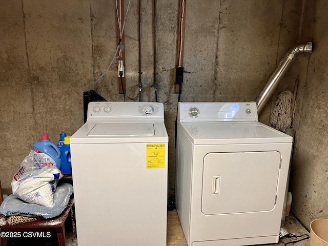 clothes washing area featuring laundry area and washer and clothes dryer