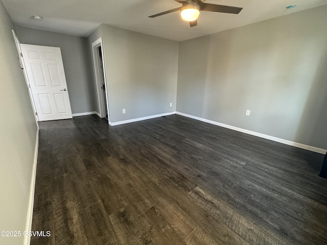 interior space with dark wood-style floors, ceiling fan, and baseboards