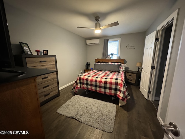 bedroom featuring dark wood-type flooring, a wall unit AC, baseboards, and a ceiling fan