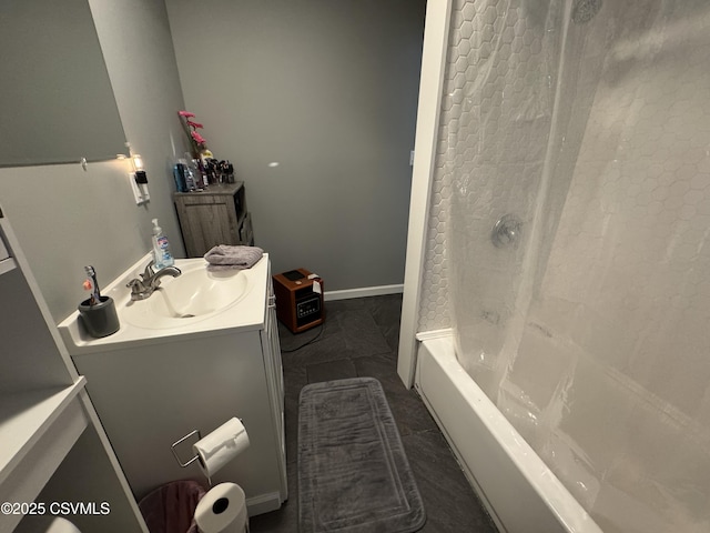 full bath with washtub / shower combination, vanity, and baseboards