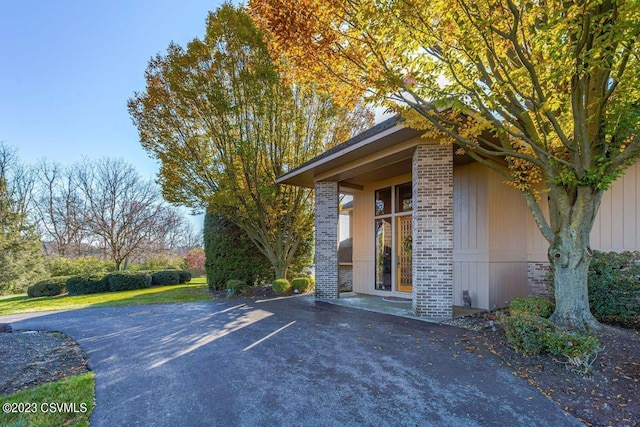 doorway to property with brick siding