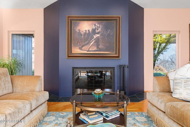 living area featuring a fireplace with flush hearth