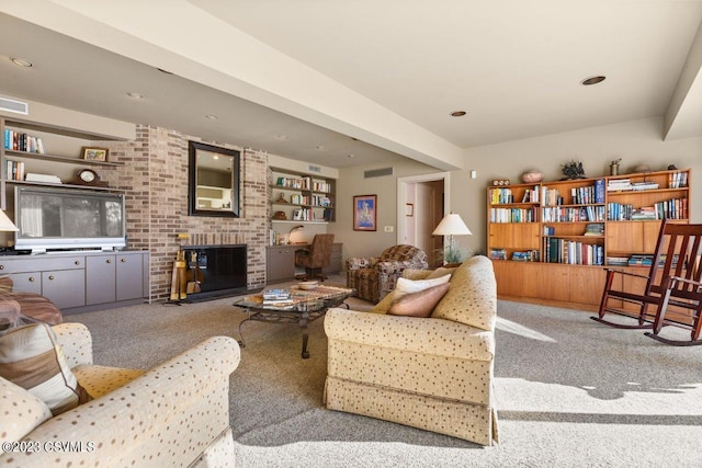 carpeted living room with a brick fireplace