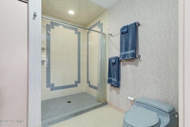 bathroom featuring a stall shower, tile patterned flooring, toilet, and wallpapered walls