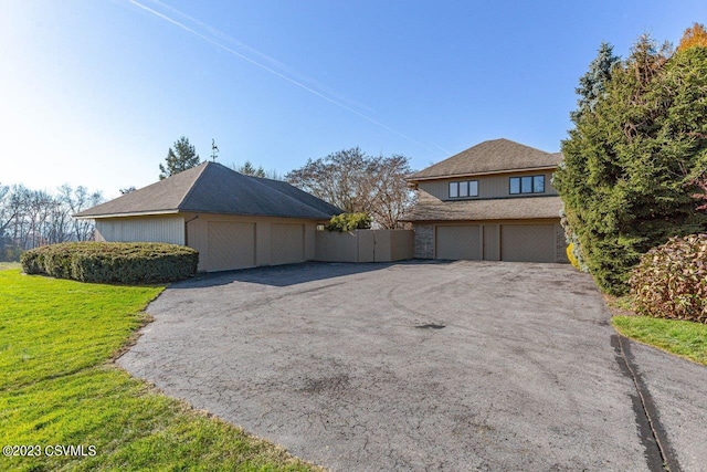 view of front of house with fence and a front lawn