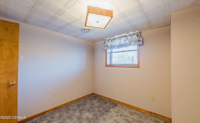 unfurnished room featuring carpet flooring, visible vents, and baseboards