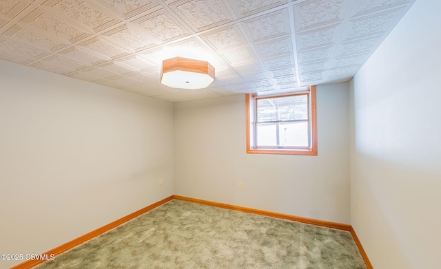 unfurnished room featuring baseboards, an ornate ceiling, and carpet floors