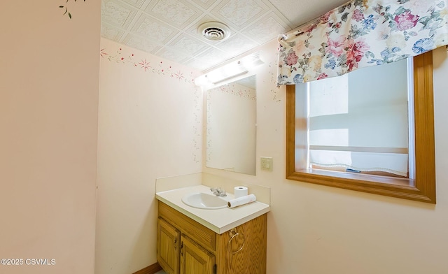 bathroom with visible vents, an ornate ceiling, and vanity