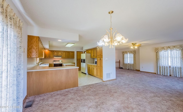 kitchen featuring visible vents, electric stove, white refrigerator with ice dispenser, open floor plan, and light colored carpet