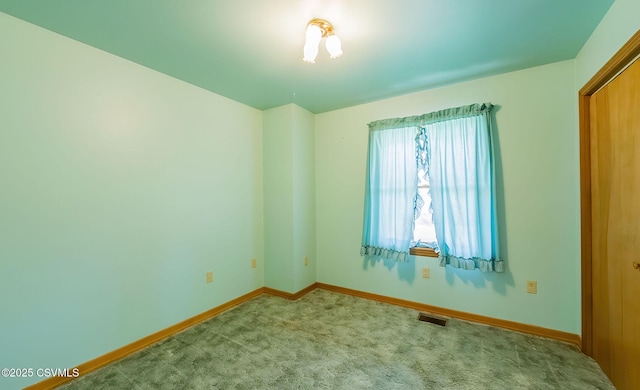 spare room with visible vents, baseboards, and carpet floors