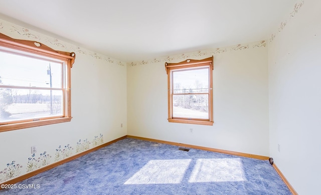 carpeted spare room with baseboards