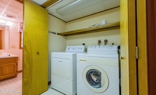 washroom with washer and clothes dryer, laundry area, light floors, and visible vents