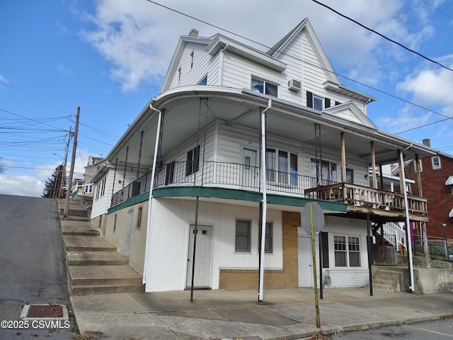 view of property featuring stairs and brick siding