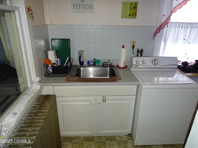 laundry area with washer / clothes dryer, a sink, and cabinet space