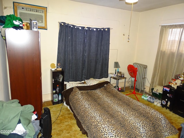 bedroom featuring radiator and a wall unit AC