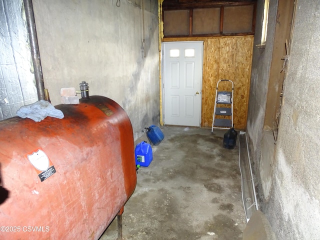 interior space with unfinished concrete floors and heating fuel