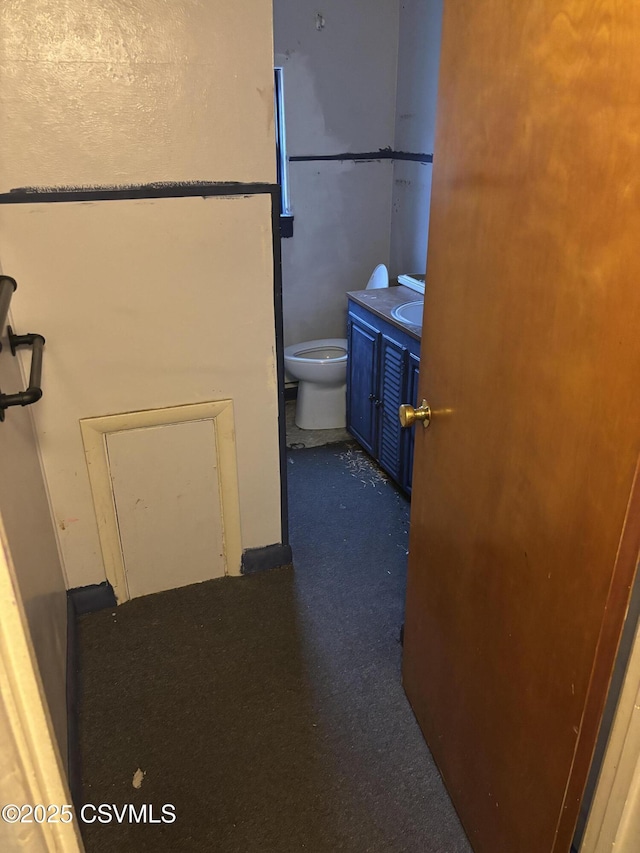 bathroom with toilet and vanity