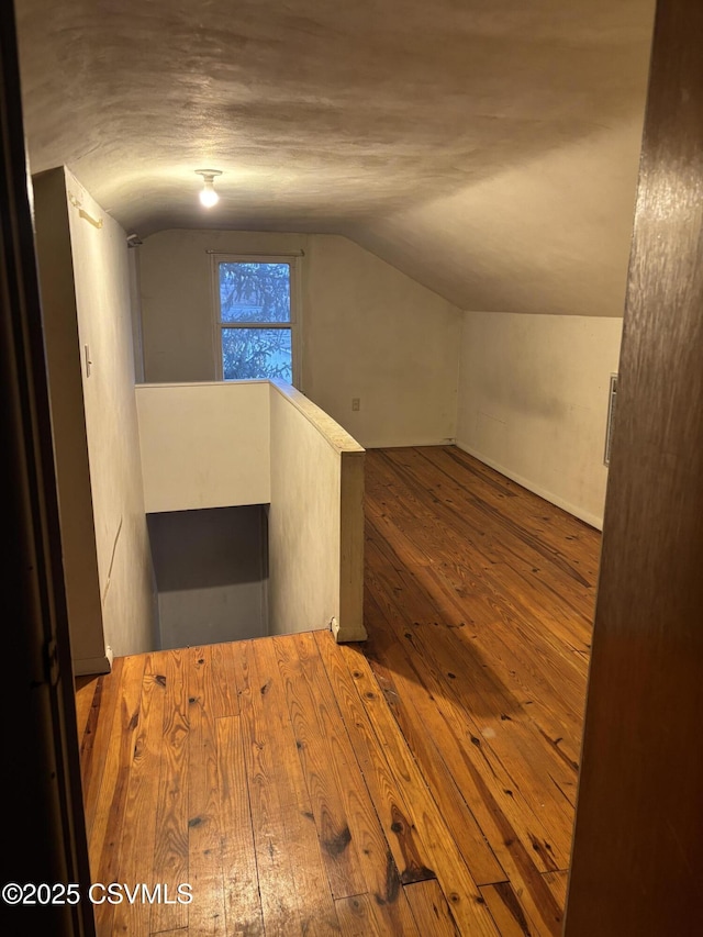 bonus room featuring lofted ceiling and hardwood / wood-style floors