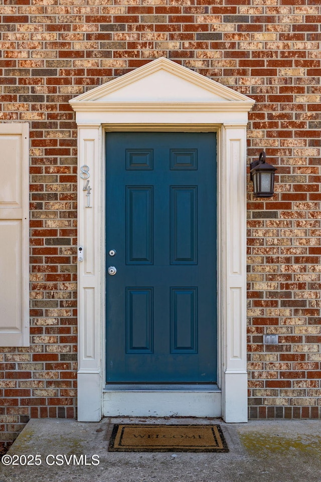 property entrance with brick siding