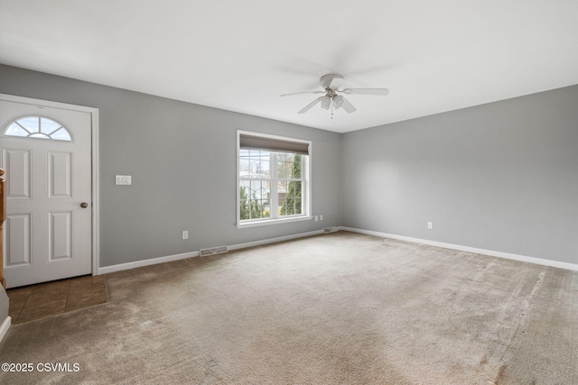 foyer entrance featuring ceiling fan, carpet, visible vents, and baseboards