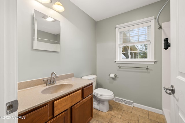 bathroom with visible vents, toilet, vanity, tile patterned flooring, and baseboards