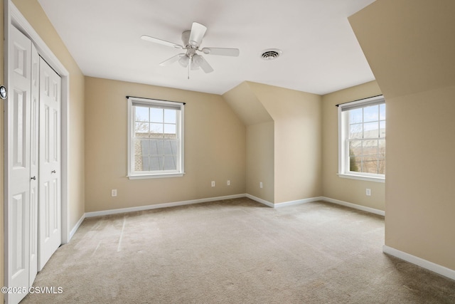 bonus room with baseboards, visible vents, ceiling fan, and carpet flooring