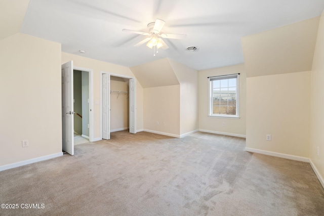 bonus room with lofted ceiling, carpet floors, visible vents, and baseboards