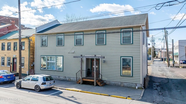 multi unit property featuring a shingled roof