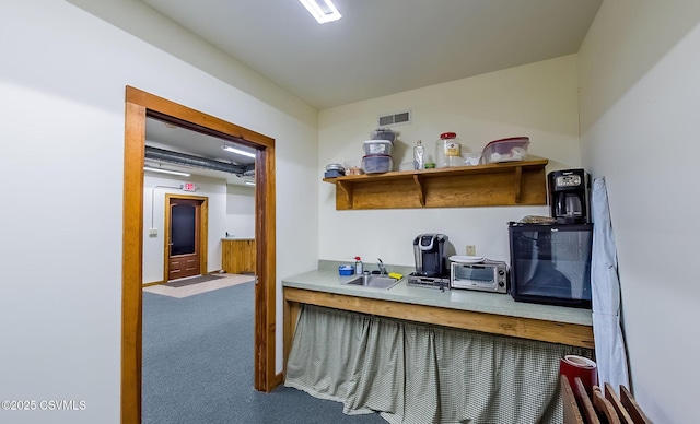 home office featuring a toaster, carpet, visible vents, and a sink