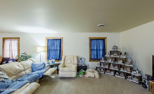 living area featuring visible vents and carpet floors