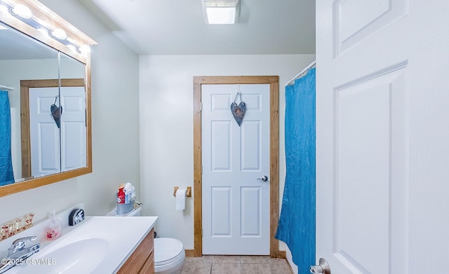 bathroom with vanity, tile patterned floors, and toilet