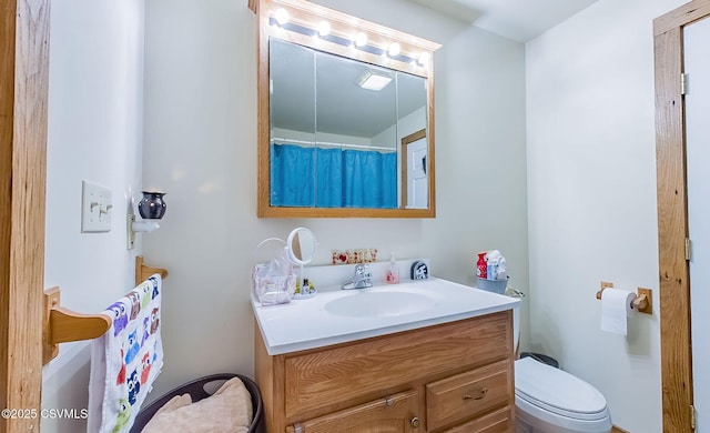 bathroom featuring vanity and toilet